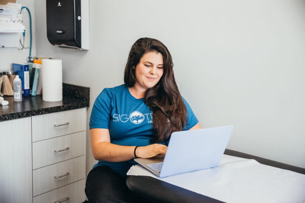 Big Tree medical staff in examination room looking at laptop