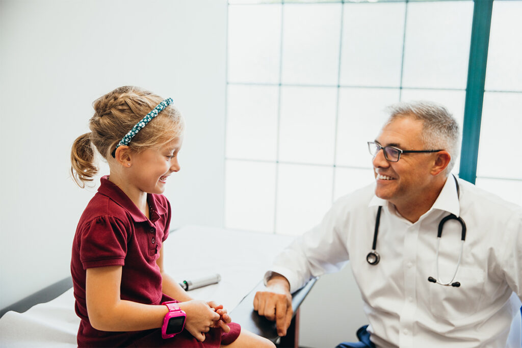 Doctor Wheeler talking to pediatric patient